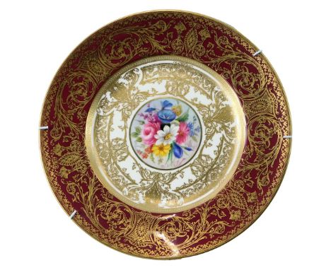 A Royal Worcester porcelain cabinet plate, decorated centrally with a floral spray signed by PH Price, against a cream ground