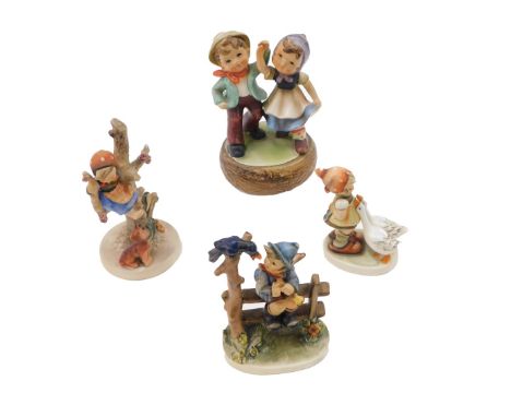 Three Goebel Hummel figures, to include boy on a fence, girl in a tree, etc., and a similar musical group of two people. (4)