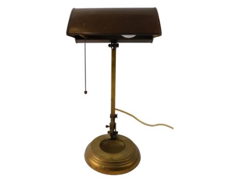 An early 20thC brass banker's desk lamp, with domed shade, adjustable column, and circular weighted base, 51cm high. WARNING!