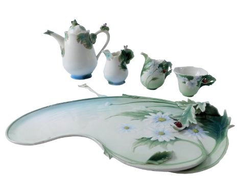 A Franz porcelain part tea coffee service, comprising coffee pot, 16cm high, cup and spoon, two jugs, and a tray, 34cm wide. 