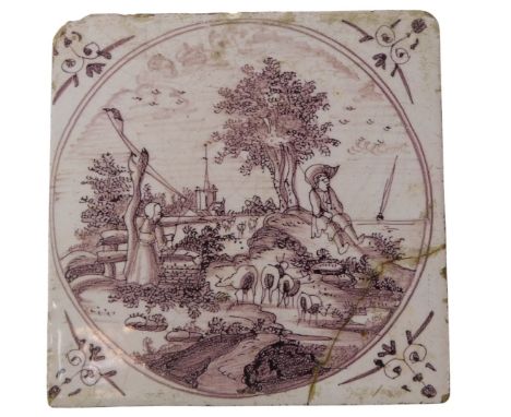 An 18thC manganese Delft tile, decorated with a landscape, 13cm wide.