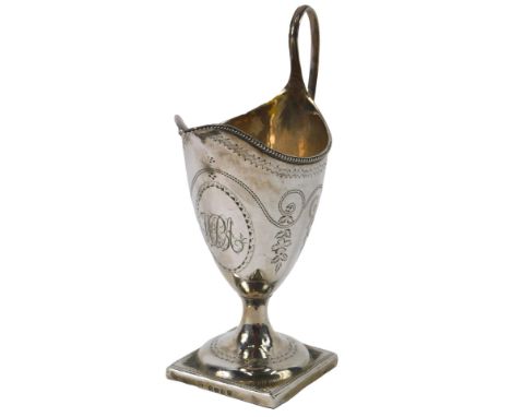 A George III helmet shaped cream jug, with engraved decoration and monogram with an oval on square base, London 1791, 2.94oz.