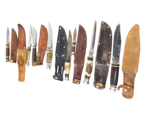 A collection of hunting knives, some with antler handles, one with a blade marked William Rogers made in Sheffield England, l