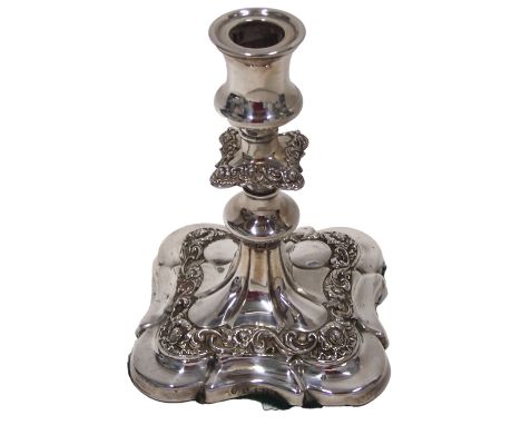 An Edwardian silver candlestick, the knopped stem decorated with scrolls, etc., on a tapering square base, loaded, Birmingham