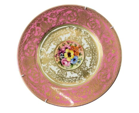 A Royal Worcester porcelain cabinet plate, decorated centrally with a floral spray signed by J Freeman, against a cream groun