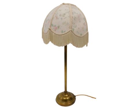 An early 20thC brass table lamp, with domed foot and associated frilled shade, 70cm high. WARNING! This lot contains untested