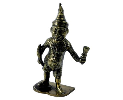 A 19thC brass figure, modelled as Punch, holding a quill and ink pot, on a shaped base, 13cm high. 
