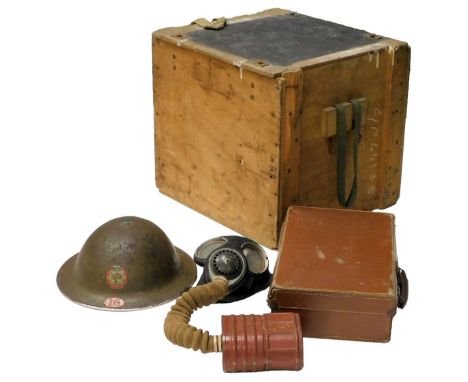 A WWII British helmet, dated 1938 to the liner, National Fire Service transfer on the front, and number 16 Lyndhurst District