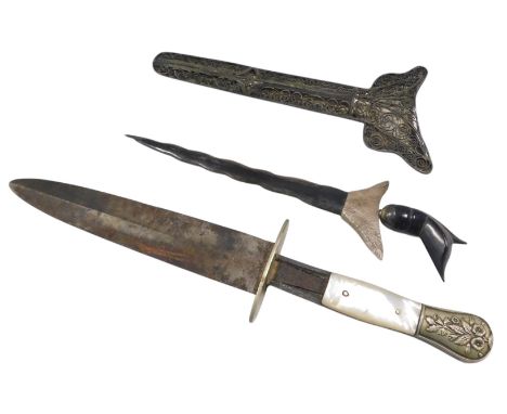An Eastern white metal ornamental Kris, indistinctly stamped with filigree scabbard, horn handle, and a small dagger with mot