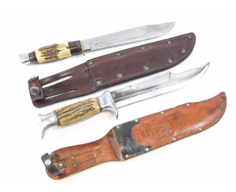 A pair of antler handled hunting/bowie knives, both in leather sheaths, one with aluminium fittings, and blade marked Edge Br