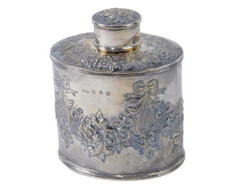 A late Victorian oval silver tea caddy, embossed with flowers, leaves, etc., Birmingham 1891, 4.69oz, 11cm high.