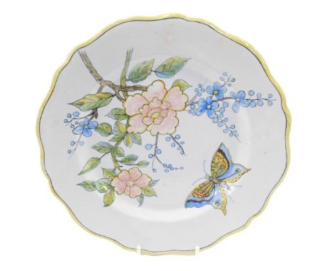 A 19thC Porquier Beau Faience botanical plate, decorated with a butterfly, 23cm diameter.