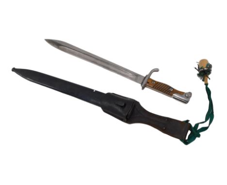 A German WWI Mauser bayonet, made by R. Stott &amp; Co, dated 1915 to the spine, includes scabbard, leather frog, and green s