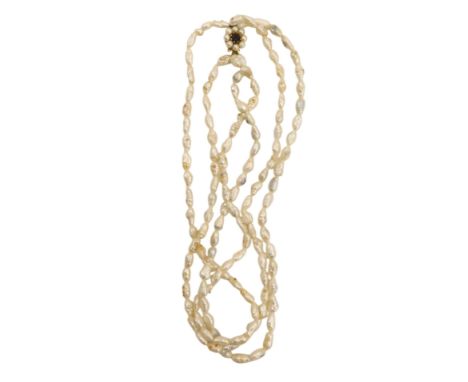 A three strand natural pearl necklace, with a cream overall lustre, the pendant formed as cluster, with central garnet, stamp