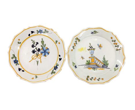 An early 20thC French Faience plate, decorated with a balustrade and urn, and another decorated with flowers, possibly La Roc