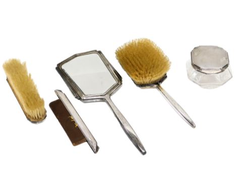 A George VI silver mounted part dressing table set, comprising glass jar and cover, hand brush, mirror, clothes brush, mount 