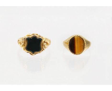 Two Gold Signet Rings.  To include a 15ct Gold Shield Shaped Cabochon Bloodstone Signet Ring and a 9ct Gold Oval Cabochon Tig