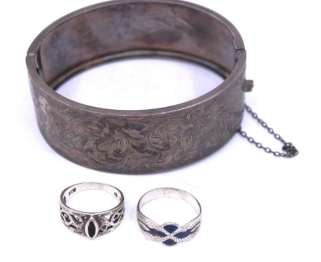 A Sterling Silver Bangle and two Sterling Silver Rings (A/F).  The Sterling Silver Hinged Bangle is hallmarked with the Lion 