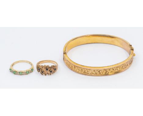 A selection of 9ct Gold Jewellery. To include a 9ct Gold Patterned Hinged Bangle, a 9ct Gold Sapphire Ring and a 9ct Gold Eme