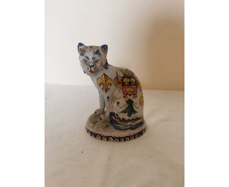 A French faience pottery seated cat, Quimper style, with Fleur de Lis and family crest painted to the side. Marked CA underne