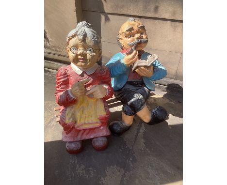 Large pair of seated figures on a separate wooden bench-The figures are made of fibreglass and there is some small area of da