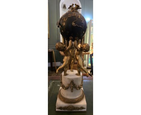 A Samuel Marti Bronze ormolu Globe clock with key. Late 19th century. The case shaped as a globe and embellished with ormolu 
