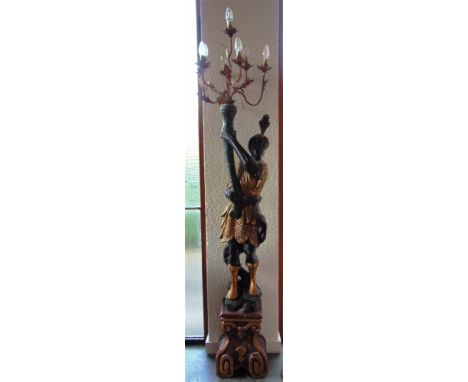 A CARVED WOODEN PAINTED AND GILDED BLACKAMOOR FIGURE  supporting a seven light lamp, 217cm high overall 