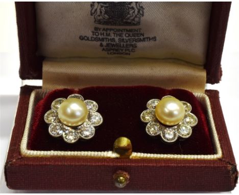 A PAIR OF CULTURED PEARL AND DIAMOND FLOWER-HEAD CLUSTER STUD EARRINGS  each centred with a light-cream cultured pearl approx