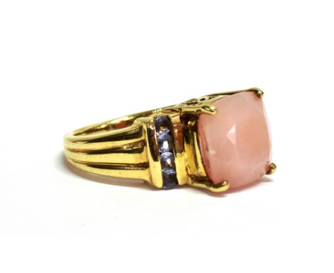 A MODERN 9CT GOLD, 'PINK OPAL AND TANZANITE' RING  the facetted cushion-shaped 'pink opal' claw set between 'tanzanite' four 