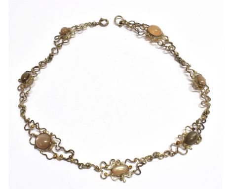 A SILVER AND MOONSTONE ABSTRACT WIREWORK NECKLACE  the seven graduated round and oval moonstone cabochons of varying hues fro