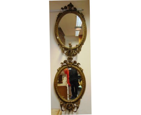 A PAIR OF GILT GESSO THREE LIGHT GIRANDOLES  the oval mirrors 59cm x 43cm