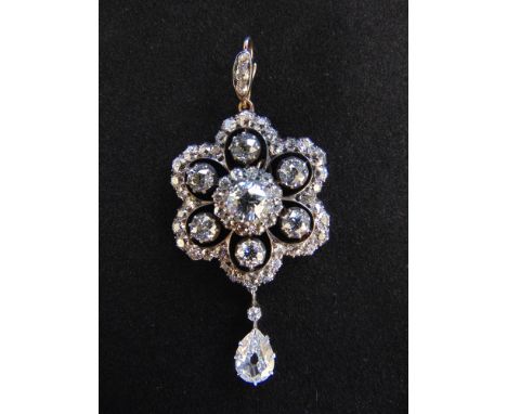 A VICTORIAN DIAMOND HEXAFOIL PENDANT WITH A PEAR-SHAPED DIAMOND DROP cut-away collet set throughout with old-cut diamonds in 