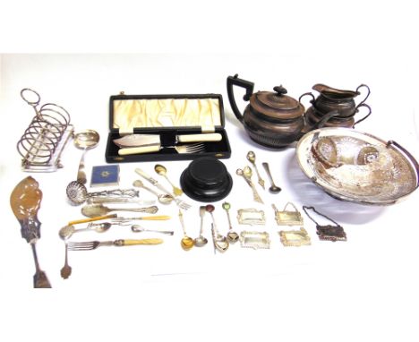 A COLLECTION OF PLATED ITEMS INCLUDING AN OVAL PART FLUTED THREE PIECE TEA SERVICE A six division toast rack; a pierced round