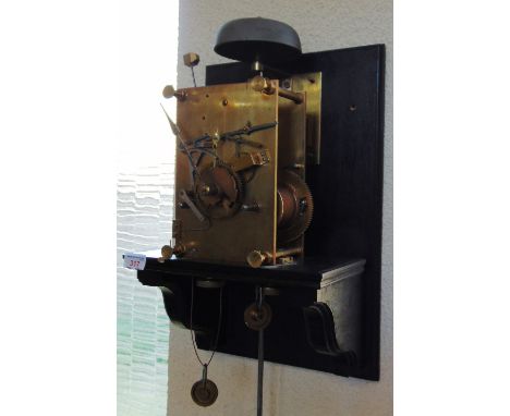 AN 8-DAY LONGCASE CLOCK MOVEMENT  with ebonsied oak stand and pendulum