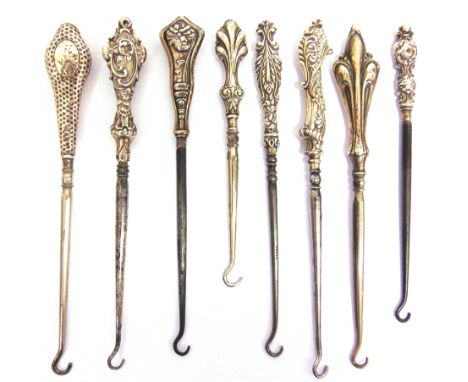 EIGHT SILVER MOUNTED STEEL BUTTON HOOKS INCLUDING A WINDSWEPT FEMALE,  comprising; a windswept lady with her hair trailing in
