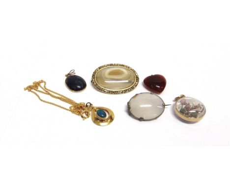 A GROUP OF FOUR MODERN PENDANTS AND TWO BROOCHES comprising; an early 20th century gold mounted &amp; glazed round pendant en