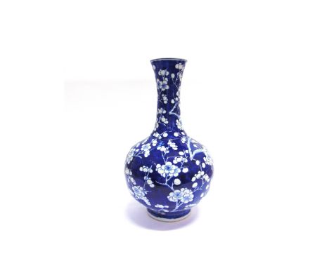 A LARGE CHINESE PORCELAIN BOTTLE VASE  decorated with prunus blossom on a cracked ice ground, underglaze blue painted four ch