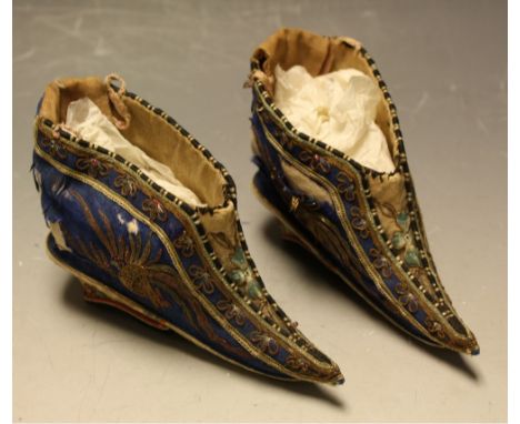 A pair of early 20th century Chinese shoes, royal blue silk, wire thread embroidered dragon and pearl to each side, embroider