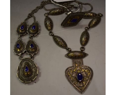 A white metal necklace, set with lapis lazuli; another, similar; a ring, set with lapis lazuli (3)