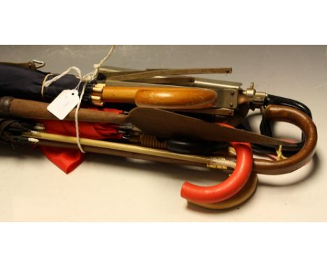 A collection of umbrellas and parasols, including a Victorian parasol; walking sticks; a shooting stick; a folding music stan