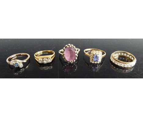 An 18ct gold diamond highlight three-stone ring, size O, 3.8g; a 9ct gold sapphire and white stone set tablet ring; a 9ct gol