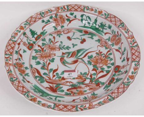 A Chinese porcelain charger, enamel decorated with a bird amongst flowers, dia. 32cm, together with a Derby pottery tea cup (