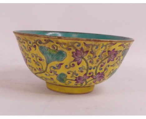 A Chinese yellow glazed footed bowl, enamel decorated with chrysanthemums, dia. 16cm