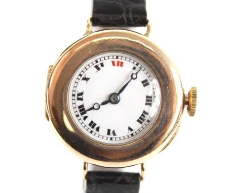 A 9ct yellow gold lady's manual wind wristwatch, having a round white Roman dial within a hinged case and fitted to a black l