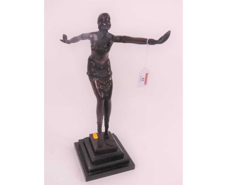 An Art Deco style bronzed metal figure of a dancer, upon a stepped black polished hardstone plinth, height 42cm