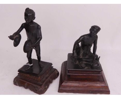 An early 20th century Indian bronze figure of a boy, shown standing holding cymbals, upon a carved hardwood base, height 18cm