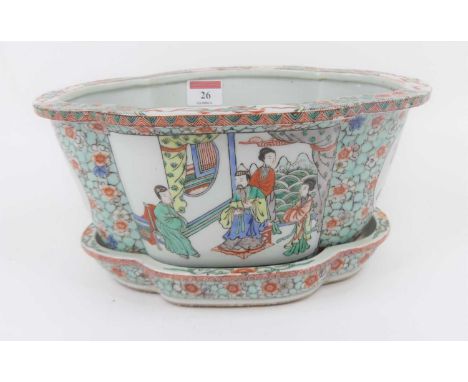 A Chinese famille verte porcelain jardiniere, enamel decorated with figures, width 28cm, upon matching standSome hard water r