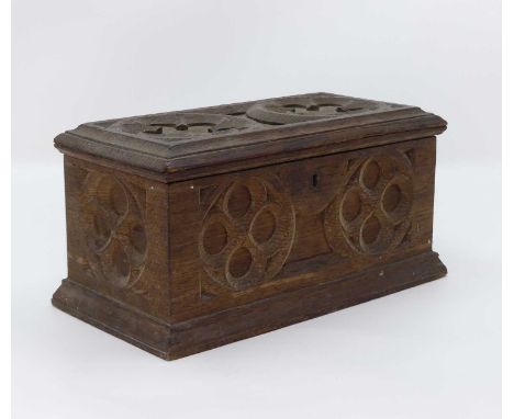 A 19th century carved oak twin compartment tea caddy, in the Gothic taste, w.24cm; together with a collection of keys