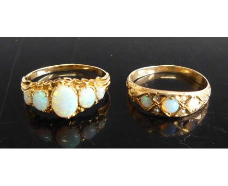 An early 20th century yellow metal opal five-stone ring, the graduated oval cabochons on a carved lozenge setting, unmarked b
