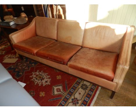 A three seater brown leather sofa, raised on tapered legs.  W.193cm D.80cm